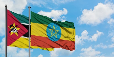 Mozambique and Ethiopia flag waving in the wind against white cloudy blue sky together. Diplomacy concept, international relations.