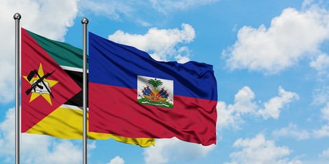 Mozambique and Haiti flag waving in the wind against white cloudy blue sky together. Diplomacy concept, international relations.