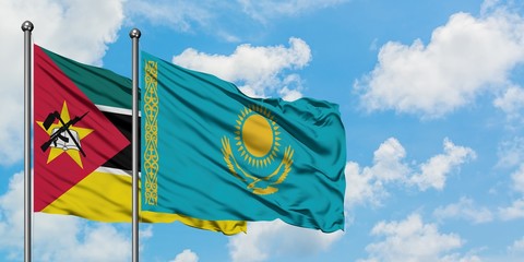 Mozambique and Kazakhstan flag waving in the wind against white cloudy blue sky together. Diplomacy concept, international relations.