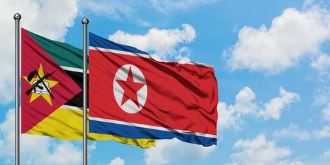 Mozambique and North Korea flag waving in the wind against white cloudy blue sky together. Diplomacy concept, international relations.