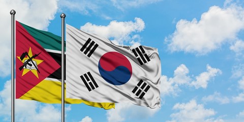 Mozambique and South Korea flag waving in the wind against white cloudy blue sky together....