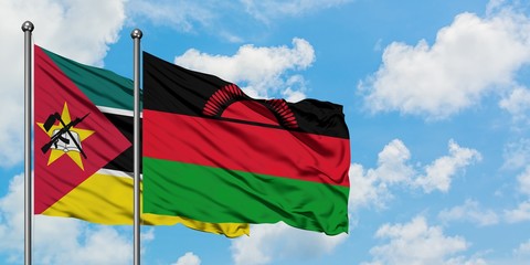 Mozambique and Malawi flag waving in the wind against white cloudy blue sky together. Diplomacy...