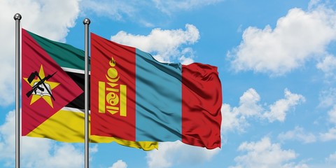 Mozambique and Mongolia flag waving in the wind against white cloudy blue sky together. Diplomacy concept, international relations.