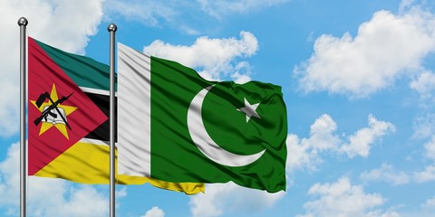 Mozambique and Pakistan flag waving in the wind against white cloudy blue sky together. Diplomacy...