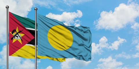 Mozambique and Palau flag waving in the wind against white cloudy blue sky together. Diplomacy concept, international relations.