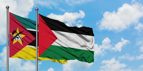 Mozambique and Palestine flag waving in the wind against white cloudy blue sky together. Diplomacy concept, international relations.