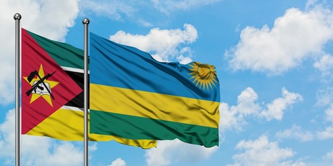 Mozambique and Rwanda flag waving in the wind against white cloudy blue sky together. Diplomacy concept, international relations.