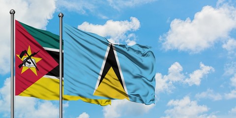 Mozambique and Saint Lucia flag waving in the wind against white cloudy blue sky together. Diplomacy concept, international relations.