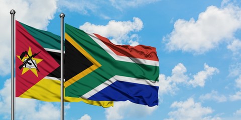 Mozambique and South Africa flag waving in the wind against white cloudy blue sky together. Diplomacy concept, international relations.