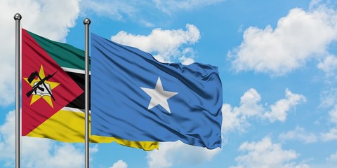 Mozambique and Somalia flag waving in the wind against white cloudy blue sky together. Diplomacy...