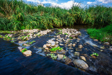 The background of the waterfall flowing from a natural blurred reservoir, natural beauty, cool fresh air