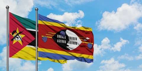 Mozambique and Swaziland flag waving in the wind against white cloudy blue sky together. Diplomacy...