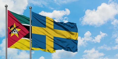 Mozambique and Sweden flag waving in the wind against white cloudy blue sky together. Diplomacy concept, international relations.