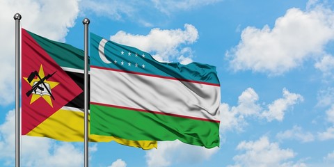 Mozambique and Uzbekistan flag waving in the wind against white cloudy blue sky together. Diplomacy concept, international relations.