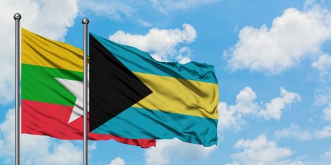 Myanmar and Bahamas flag waving in the wind against white cloudy blue sky together. Diplomacy concept, international relations.