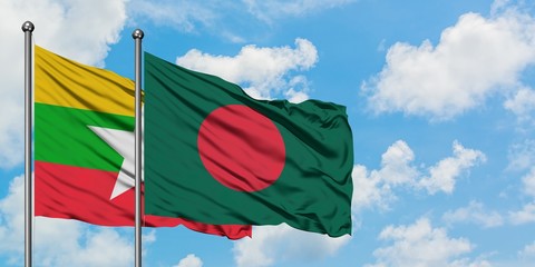 Myanmar and Bangladesh flag waving in the wind against white cloudy blue sky together. Diplomacy concept, international relations.