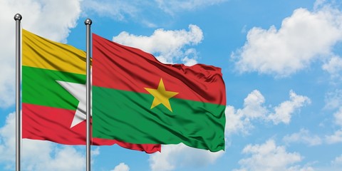 Myanmar and Burkina Faso flag waving in the wind against white cloudy blue sky together. Diplomacy concept, international relations.