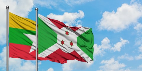 Myanmar and Burundi flag waving in the wind against white cloudy blue sky together. Diplomacy...