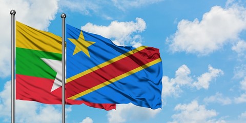 Myanmar and Congo flag waving in the wind against white cloudy blue sky together. Diplomacy concept, international relations.