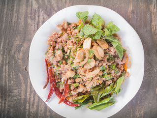 spicy minced duck and crispy fried catfish served with chili, mint  salad. Thai cuisine.