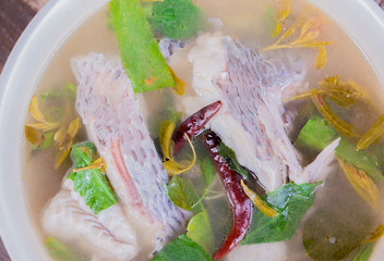 hot and sour soup tilapia fish in white plate . selective focus.