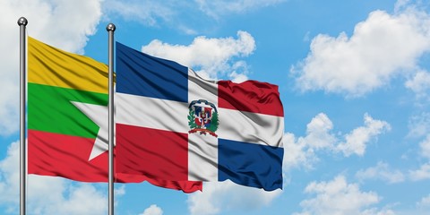 Myanmar and Dominican Republic flag waving in the wind against white cloudy blue sky together. Diplomacy concept, international relations.