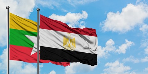 Myanmar and Egypt flag waving in the wind against white cloudy blue sky together. Diplomacy concept, international relations.