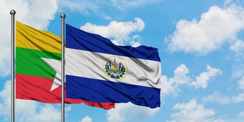 Myanmar and El Salvador flag waving in the wind against white cloudy blue sky together. Diplomacy concept, international relations.