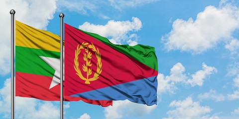 Myanmar and Eritrea flag waving in the wind against white cloudy blue sky together. Diplomacy concept, international relations.