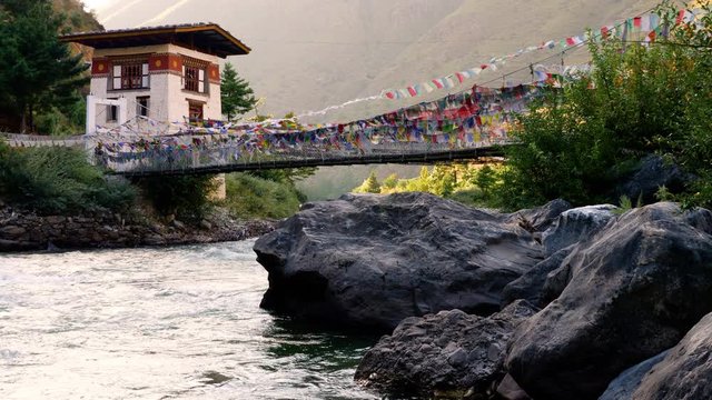 Suspension bridge covered in prayer flags near Paro, Bhutan