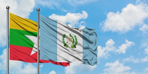Myanmar and Guatemala flag waving in the wind against white cloudy blue sky together. Diplomacy concept, international relations.