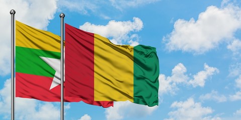 Myanmar and Guinea flag waving in the wind against white cloudy blue sky together. Diplomacy concept, international relations.