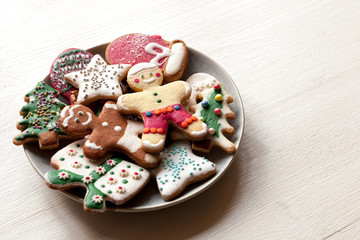Christmas cookies different shapes: star, fir-tree, present, christmas ball, mitten on white wood background, flat lay
