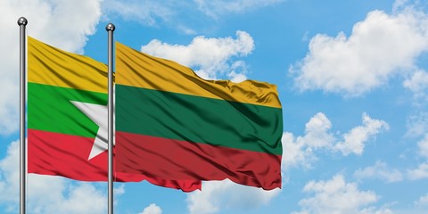 Myanmar and Lithuania flag waving in the wind against white cloudy blue sky together. Diplomacy concept, international relations.