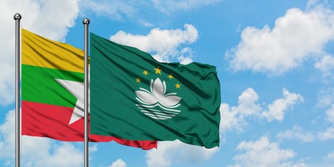 Myanmar and Macao flag waving in the wind against white cloudy blue sky together. Diplomacy concept, international relations.