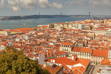 Fototapeta na wymiar Aerial view on rooftops of Lisbon with river Tagus (Tajo), Portugal