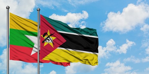 Myanmar and Mozambique flag waving in the wind against white cloudy blue sky together. Diplomacy concept, international relations.