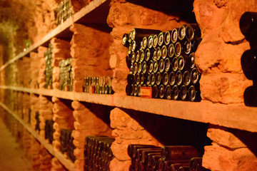 Red wine bottles in a cellar