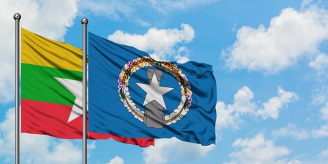 Myanmar and Northern Mariana Islands flag waving in the wind against white cloudy blue sky...