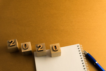 Happy New Year 2020. Symbol from number 2020 on brown background
