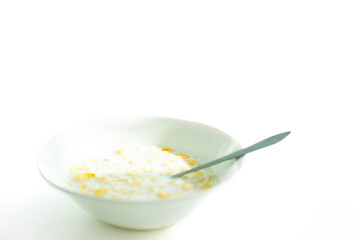 cereal with milk in a white plate for breakfast, space for text, isolate