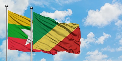 Myanmar and Republic Of The Congo flag waving in the wind against white cloudy blue sky together. Diplomacy concept, international relations.