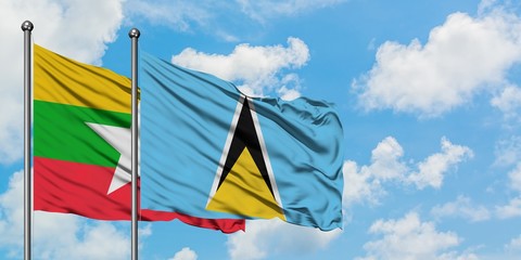 Myanmar and Saint Lucia flag waving in the wind against white cloudy blue sky together. Diplomacy concept, international relations.