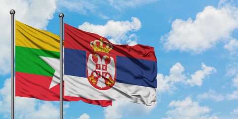 Myanmar and Serbia flag waving in the wind against white cloudy blue sky together. Diplomacy concept, international relations.