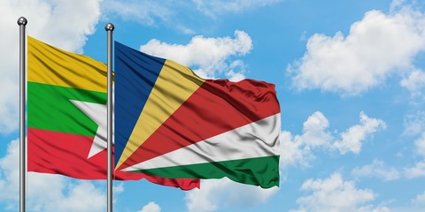 Myanmar and Seychelles flag waving in the wind against white cloudy blue sky together. Diplomacy concept, international relations.
