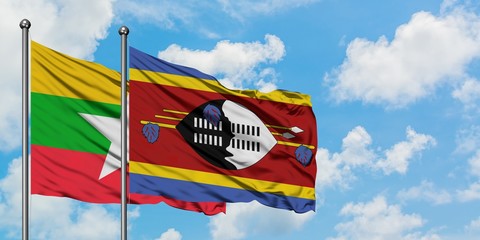 Myanmar and Swaziland flag waving in the wind against white cloudy blue sky together. Diplomacy concept, international relations.