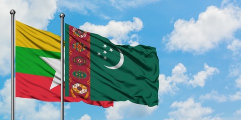 Myanmar and Turkmenistan flag waving in the wind against white cloudy blue sky together. Diplomacy concept, international relations.