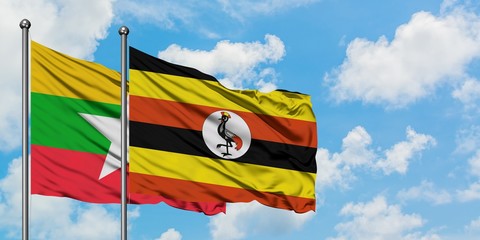Myanmar and Uganda flag waving in the wind against white cloudy blue sky together. Diplomacy concept, international relations.