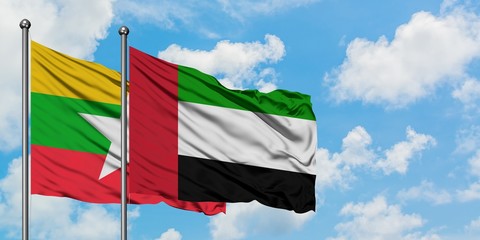 Myanmar and United Arab Emirates flag waving in the wind against white cloudy blue sky together. Diplomacy concept, international relations.
