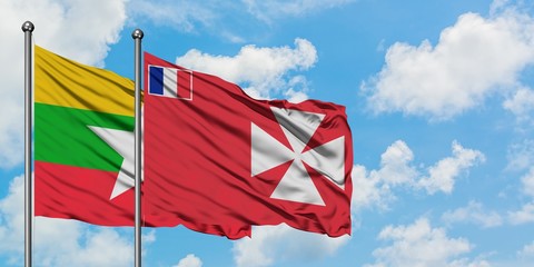 Myanmar and Wallis And Futuna flag waving in the wind against white cloudy blue sky together. Diplomacy concept, international relations.